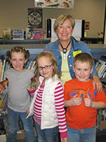 Sheryl with three young readers